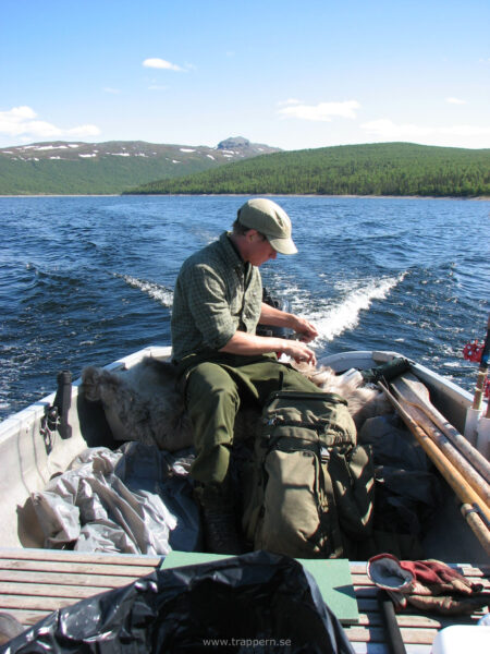 A man sits in his boat out on the lake