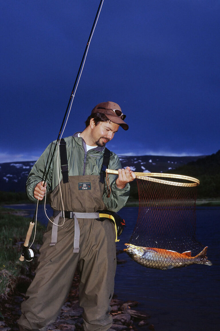 A fisherman with a freshly caught fish in his hoof